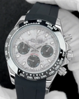 Custom seiko daytona mod with black rubber strap held by a gloved hand