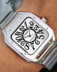 Silver Seiko watch on a wrist with a wooden background