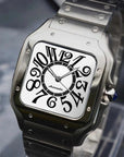 Silver watch with black face on a stand