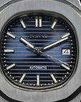 Seiko watch with blue face and silver case on a black background