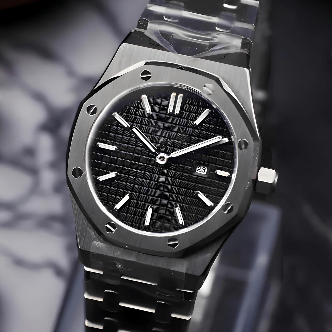 Black watch with a textured face on a dark marble surface