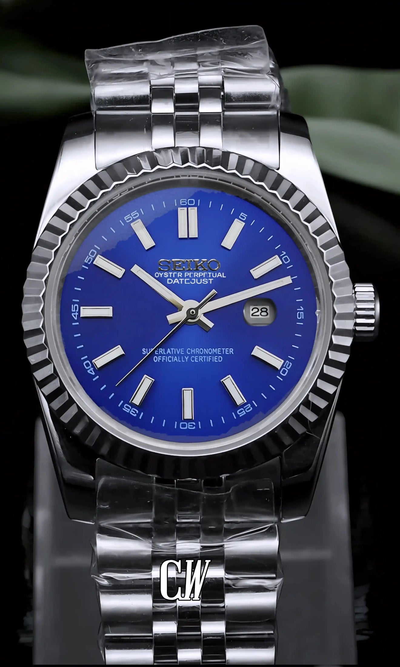 Silver watch with a blue face on a dark background