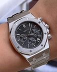 Silver watch on a wrist with a blurred background