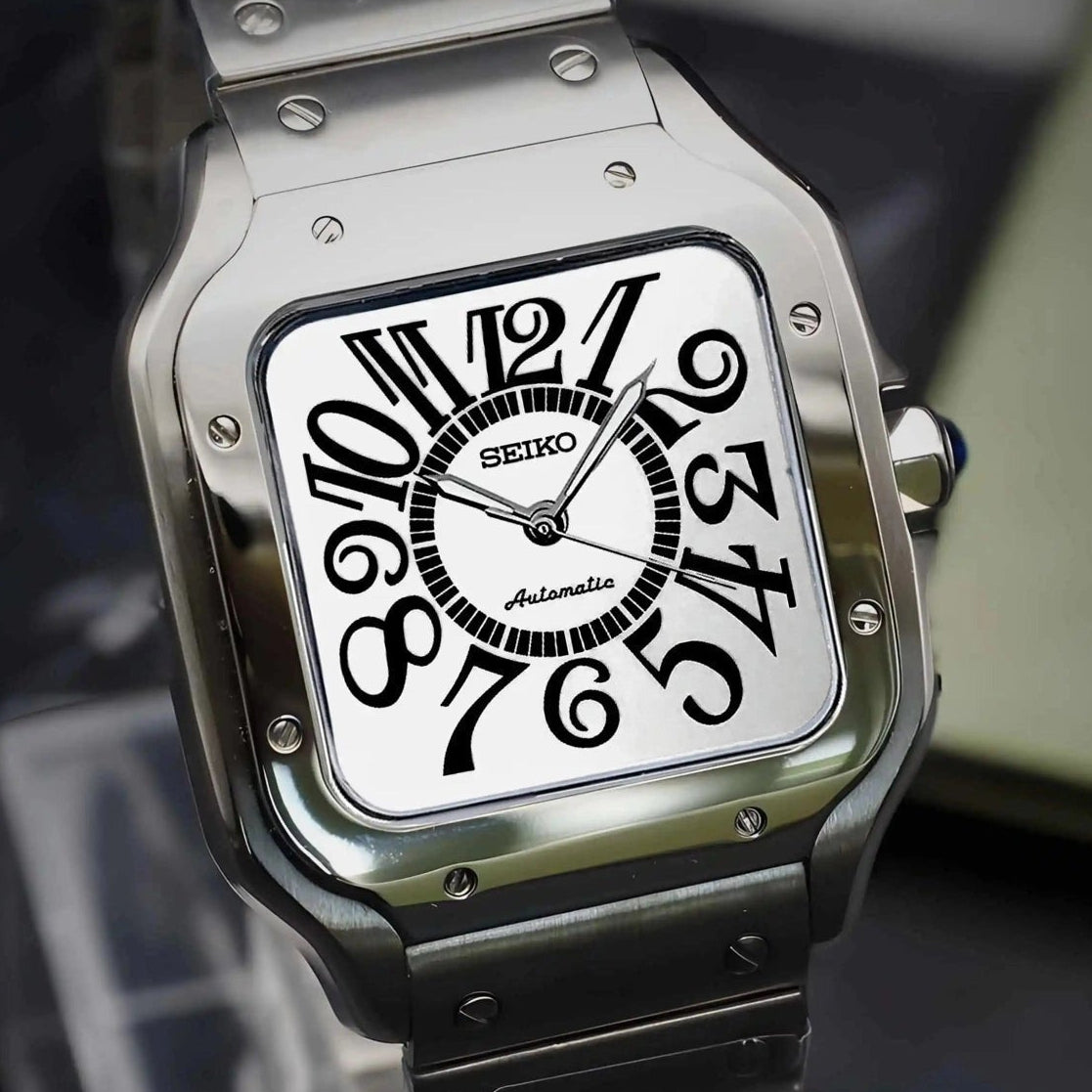 Silver Seiko watch with a white face on a dark surface
