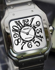 Silver Seiko watch with a white face on a dark surface