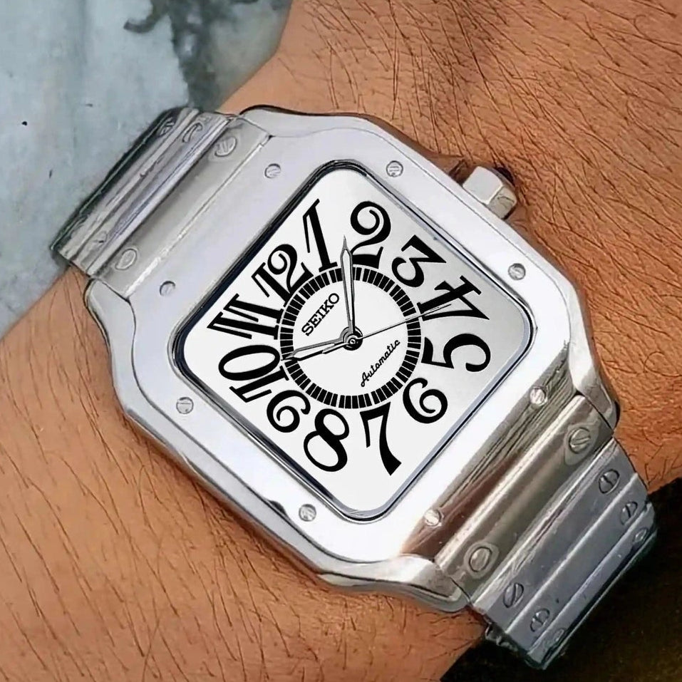 Silver Seiko watch on a wrist with a wooden background