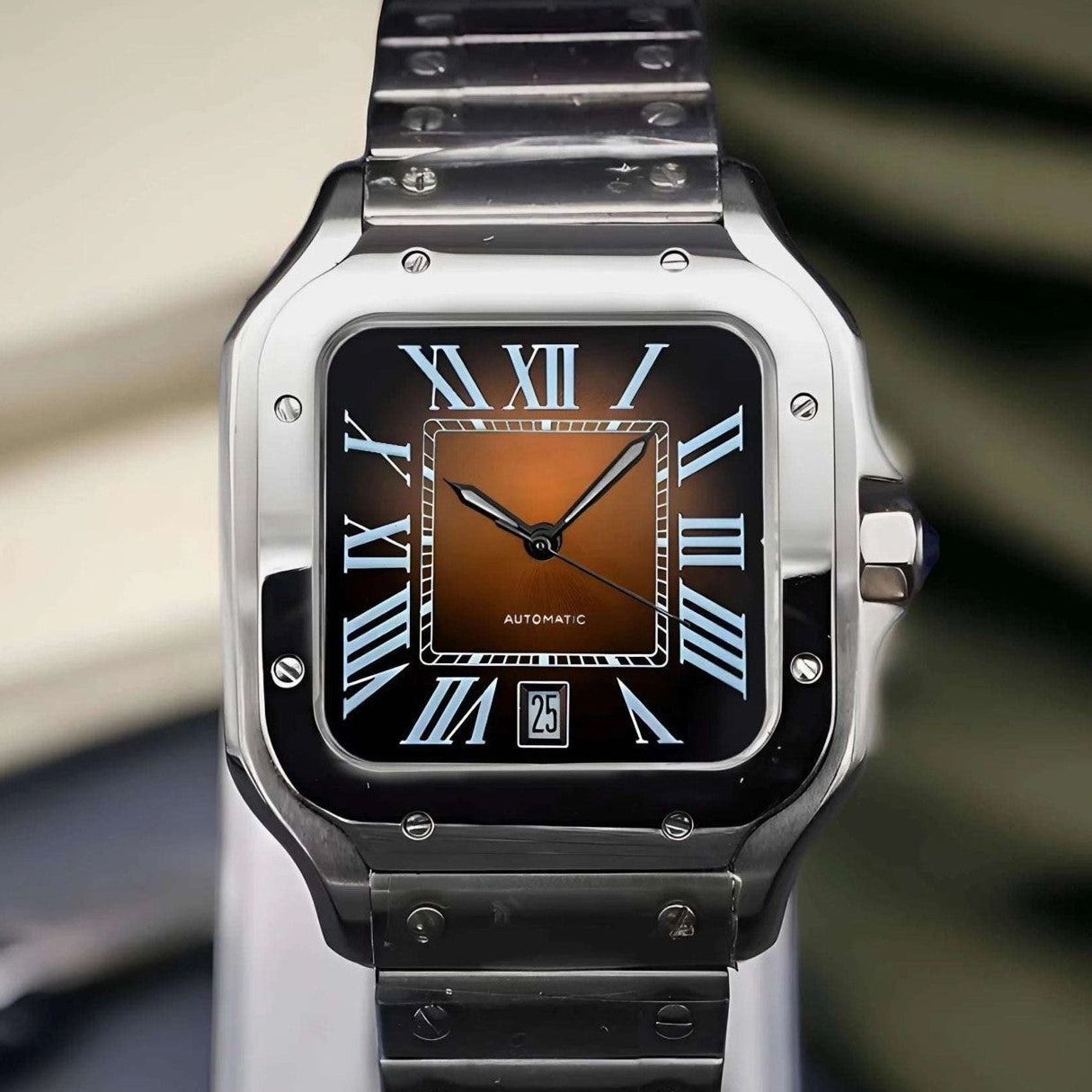 Silver watch with brown face on a stand