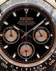 Seiko watch with black face and rose gold accents
